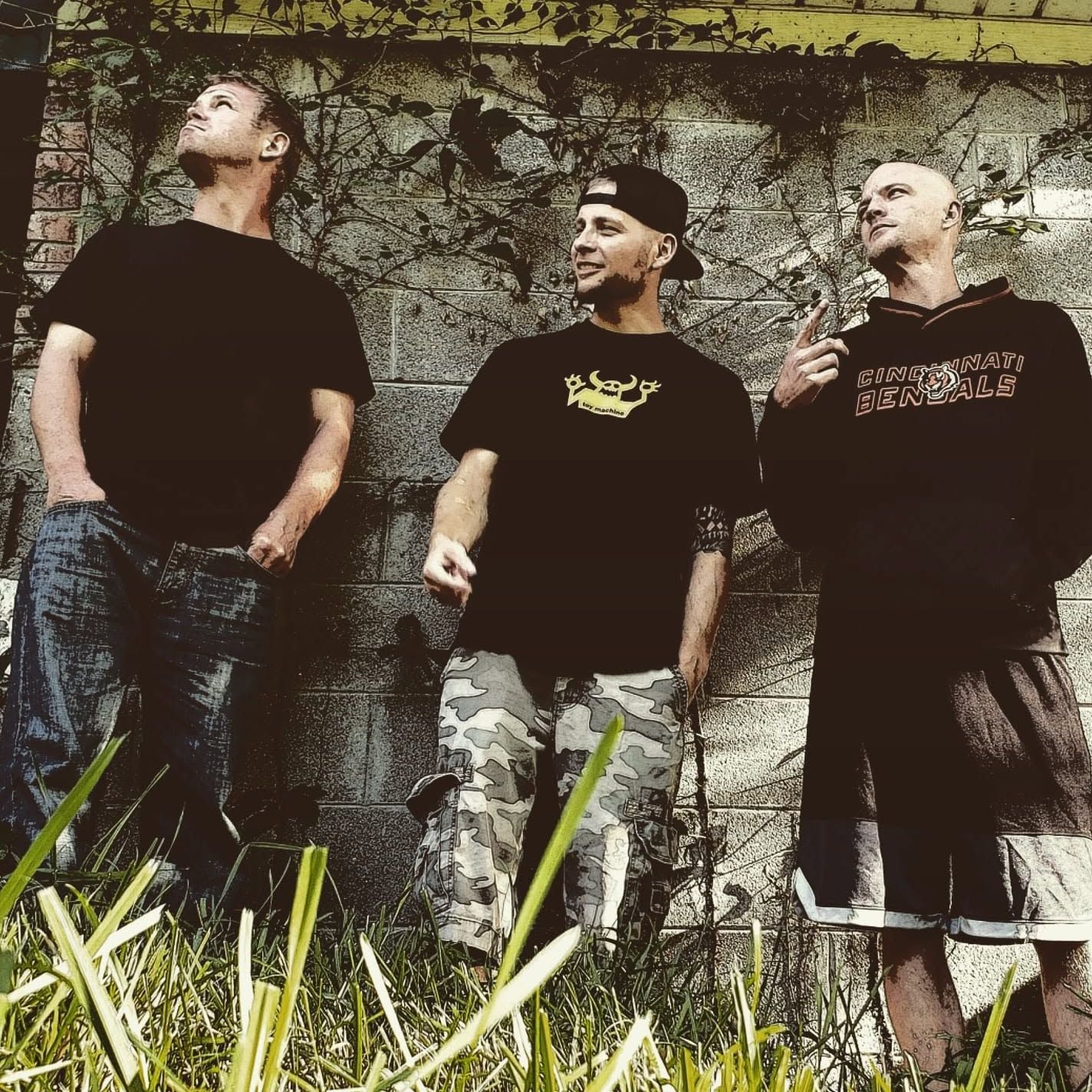 The American Scheme — the band against a vine-covered cinder-block wall